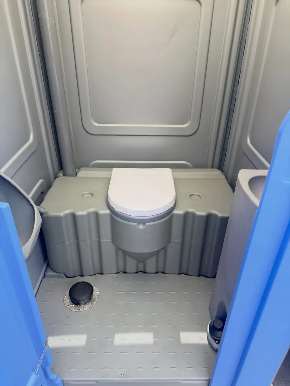 Wide, clean floor inside a large portable restroom